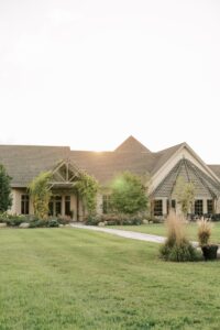 Golden hour overlooking the courtyard at RiverStone with lush green grass and beautiful gardens.